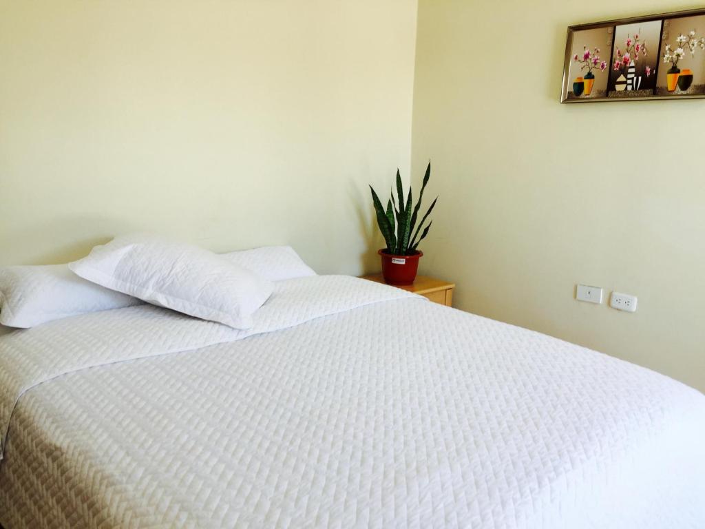 Postel nebo postele na pokoji v ubytování Quito Terrace