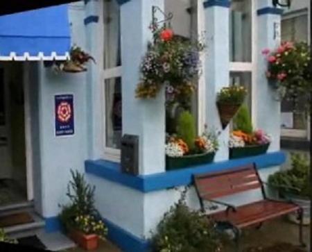 a building with potted plants on the side of it at Brixham House in Brixham