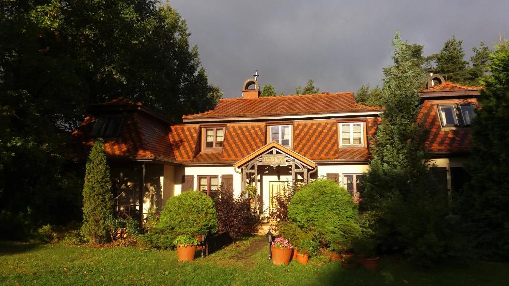 a large house with an orange tiled roof at Lisi Dwór in Czarny Młyn