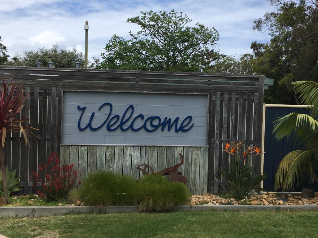 a welcome sign on the side of a building at A'Wangralea Caravan Park in Mallacoota