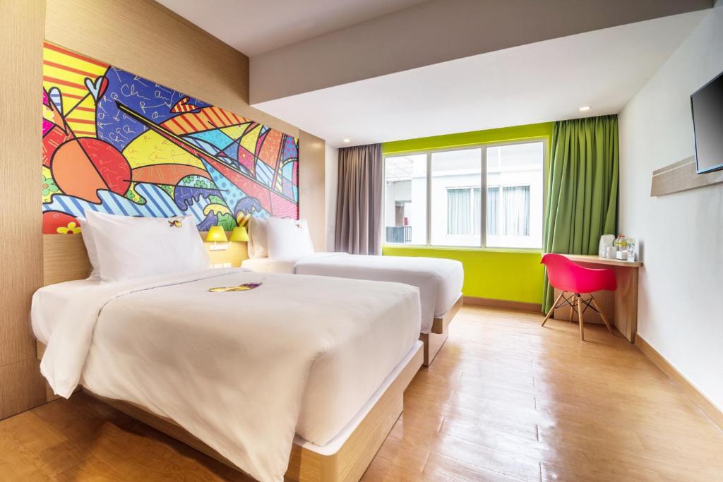 Postel nebo postele na pokoji v ubytování MaxOneHotels at Resort Makassar