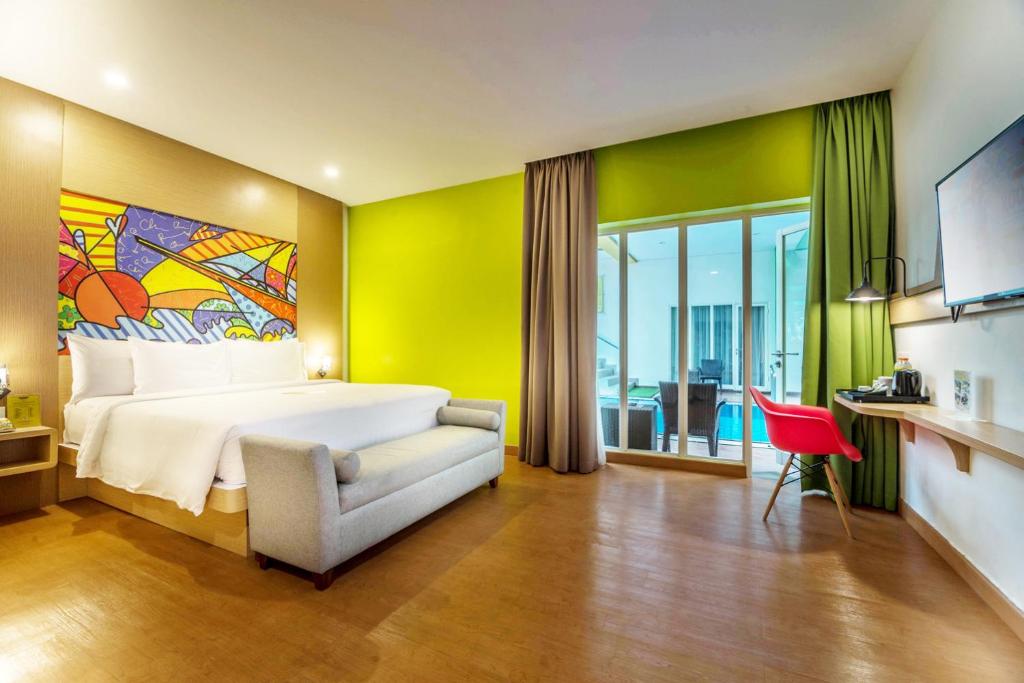 Postel nebo postele na pokoji v ubytování MaxOneHotels at Resort Makassar