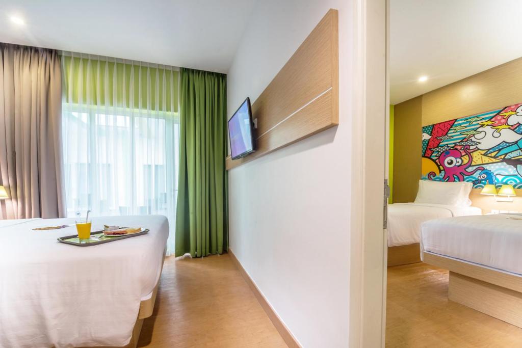 Postel nebo postele na pokoji v ubytování MaxOneHotels at Resort Makassar