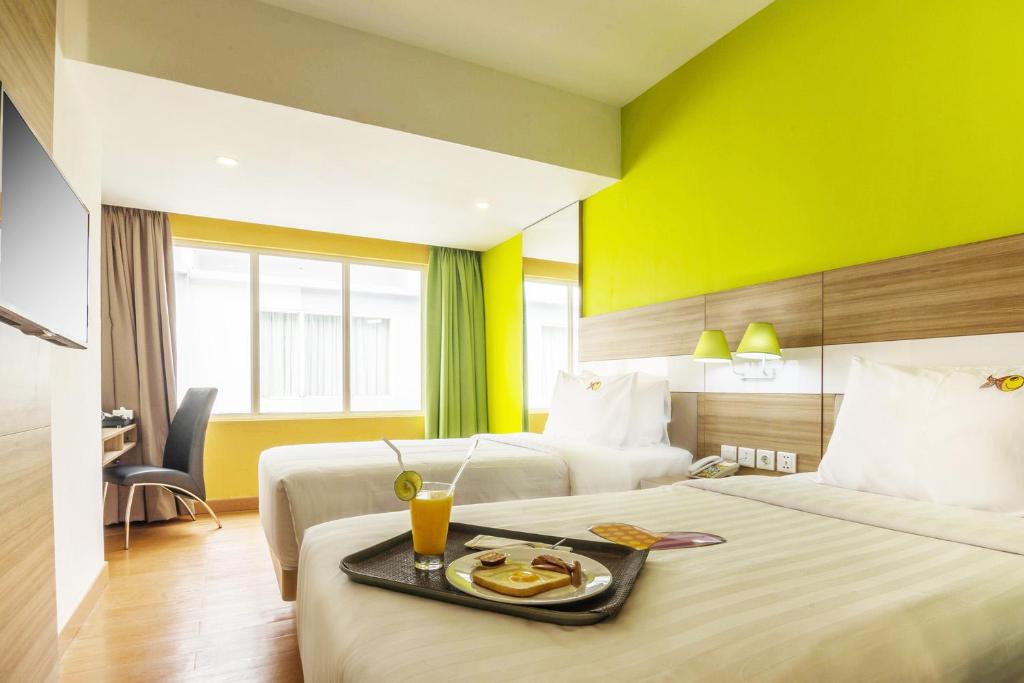 Postel nebo postele na pokoji v ubytování MaxOneHotels at Resort Makassar