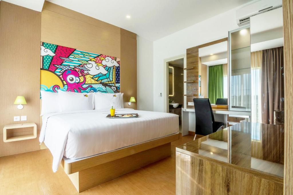 Postel nebo postele na pokoji v ubytování MaxOneHotels at Resort Makassar