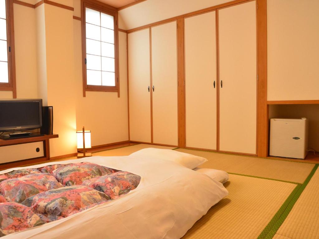 Postel nebo postele na pokoji v ubytování Hotel Ohta