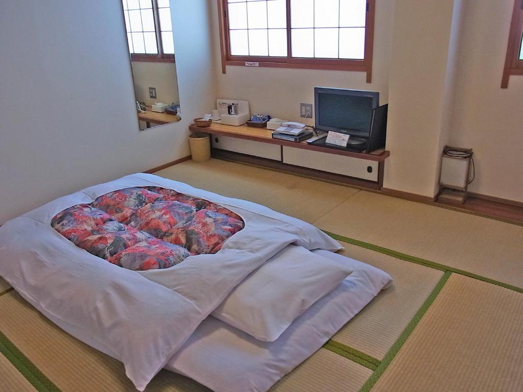 Postel nebo postele na pokoji v ubytování Hotel Ohta