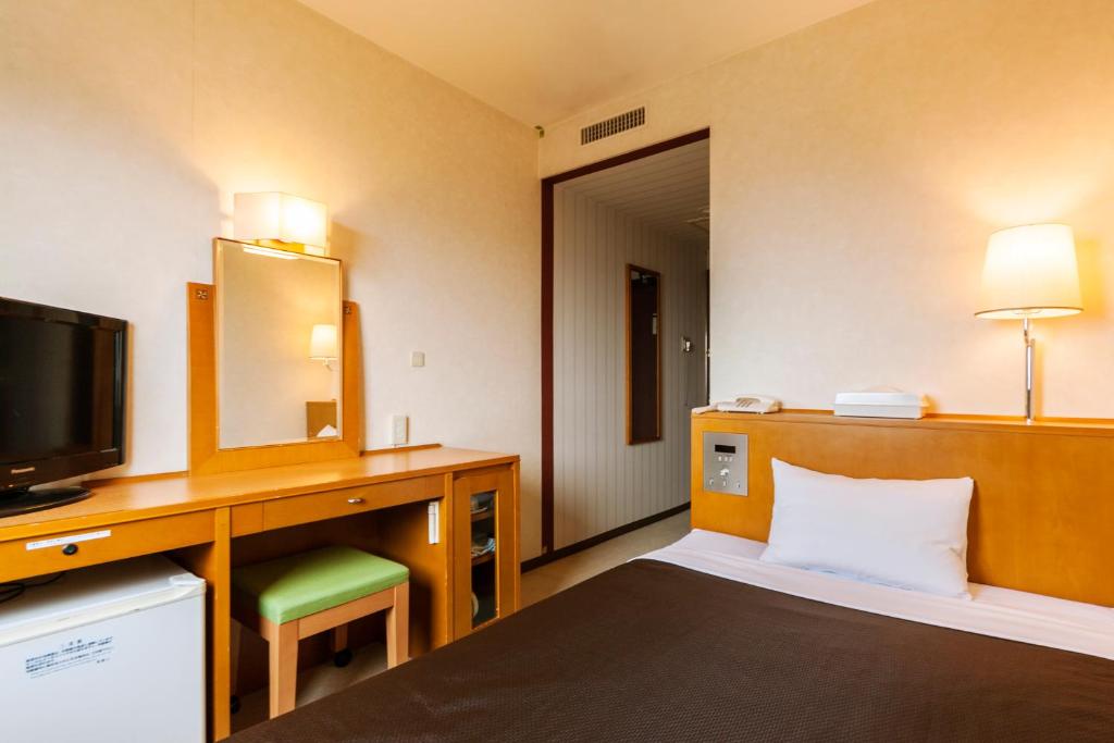 Postel nebo postele na pokoji v ubytování Komagane Premont Hotel