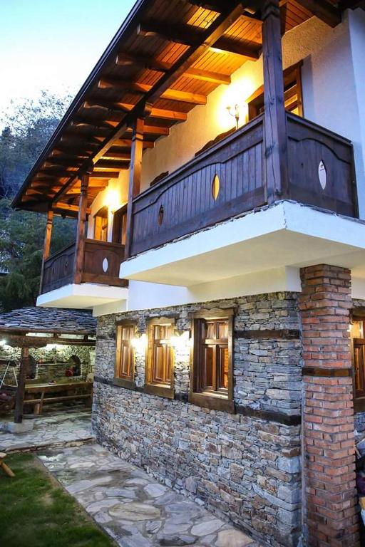 a house with a balcony on top of it at Yancheva Guest House in Delchevo