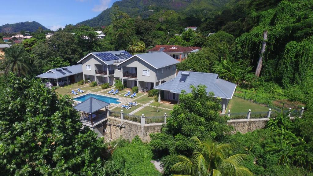 an aerial view of a house with a swimming pool at Bambous River Lodge in Bel Ombre