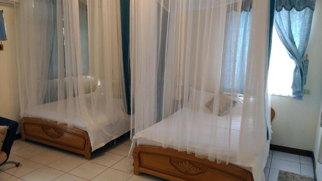 Postel nebo postele na pokoji v ubytování Breadtree Homestay