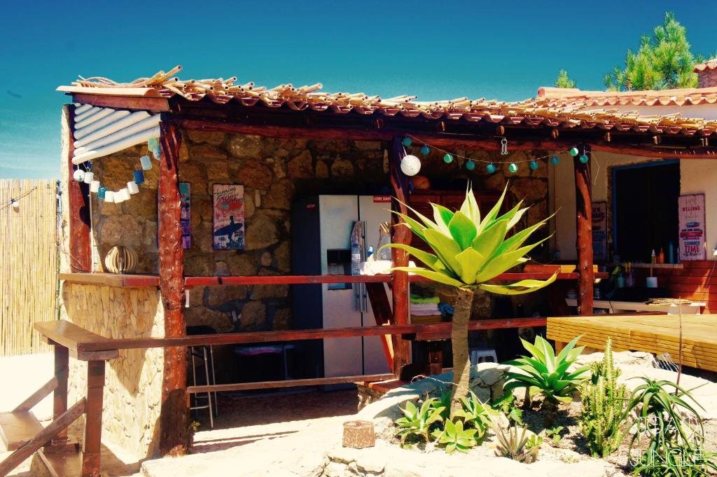 a small house with a refrigerator in front of it at João Jungle in Açafora