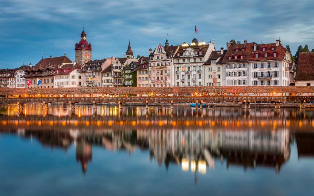 a city with a bridge over a body of water at Hotel Des Alpes in Luzern