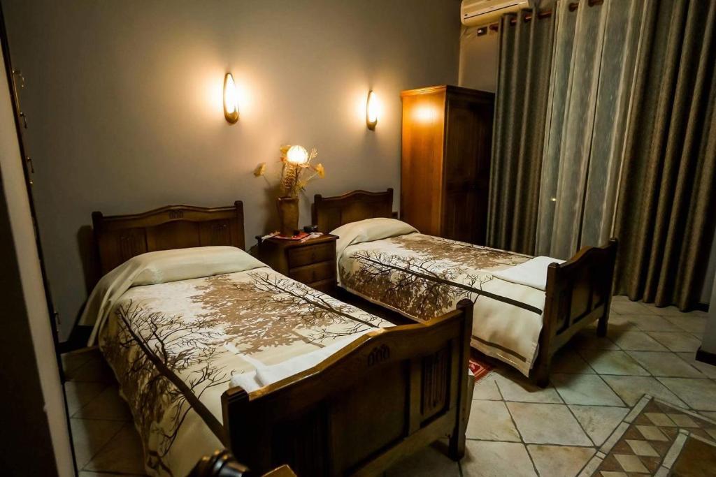Postel nebo postele na pokoji v ubytování Real Scampis Hotel