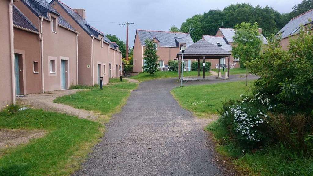 un chemin à travers un village avec des maisons dans l'établissement Domaine de l Emeraude, au Tronchet