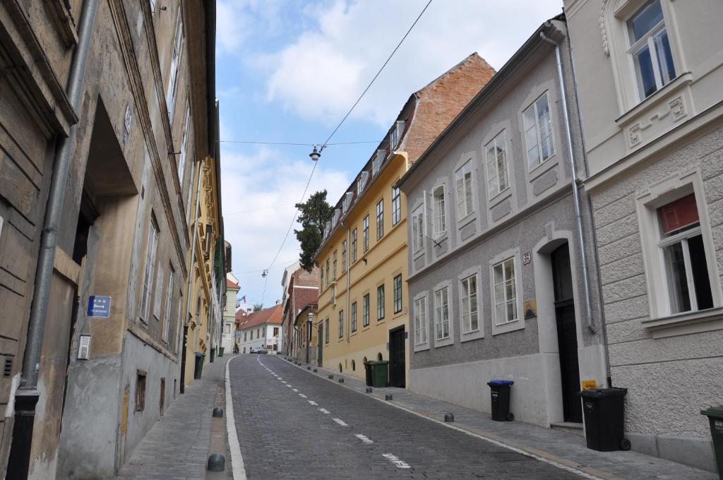 an empty street in a city with buildings at Apartment San Marco in Zagreb