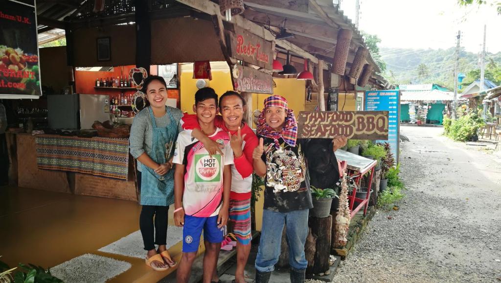 a group of people standing in front of a store at PP Red Tuna Hut in Phi Phi Don