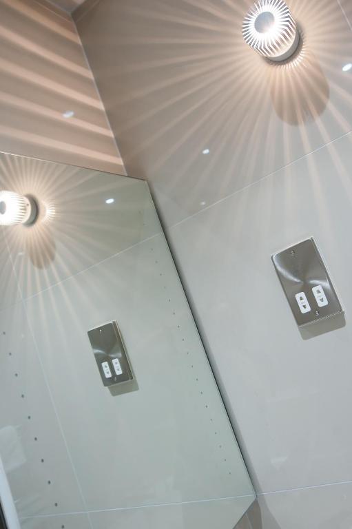 a room with three lights on the ceiling at Suites at number Ten in Broadstairs
