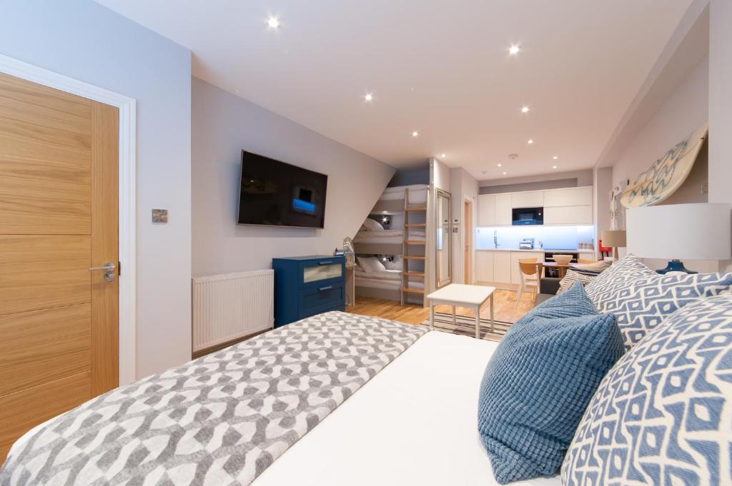 a bedroom with a bed and a room with a desk at Suites at number Ten in Broadstairs