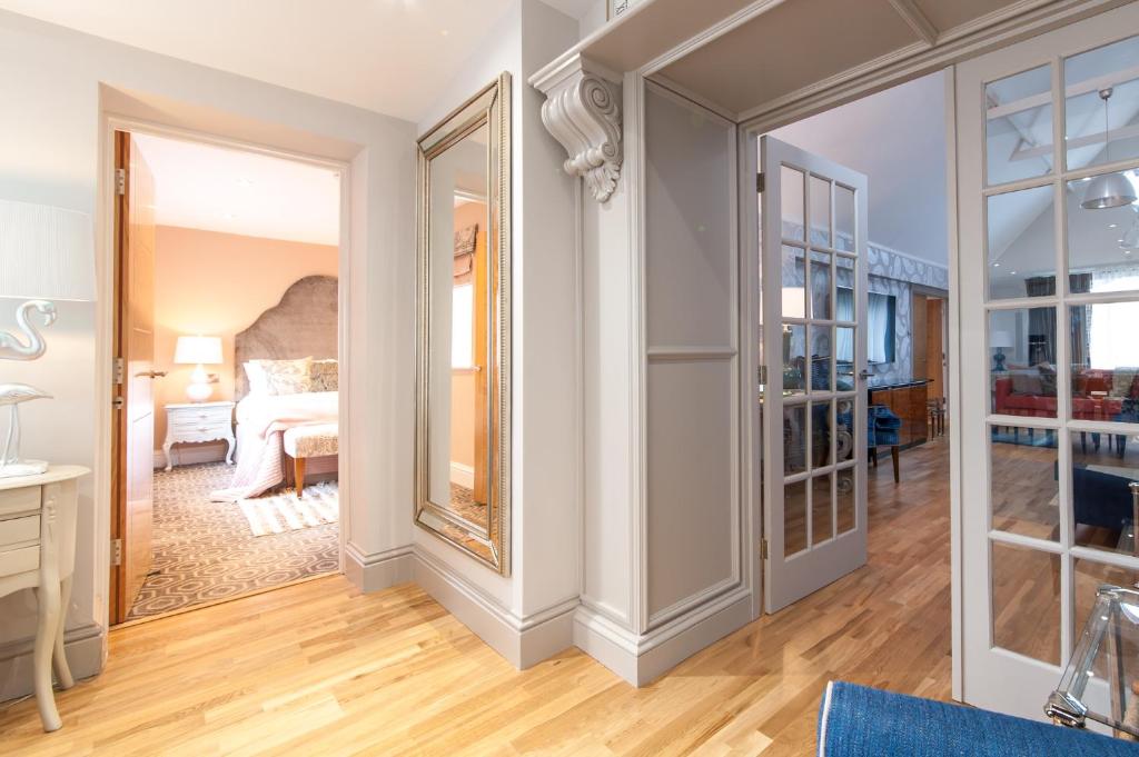a large mirror in a room with a bedroom at Suites at number Ten in Broadstairs