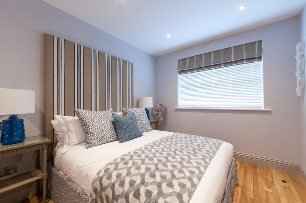 a bedroom with a large bed with a window at Suites at number Ten in Broadstairs