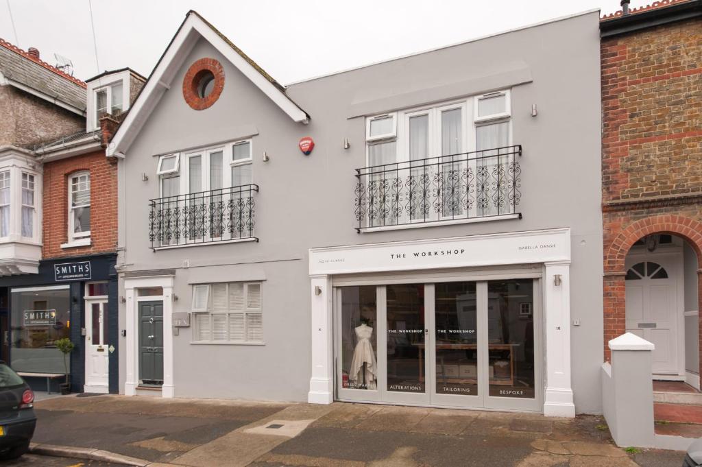 a white building with a dress in a store window at Suites at number Ten in Broadstairs