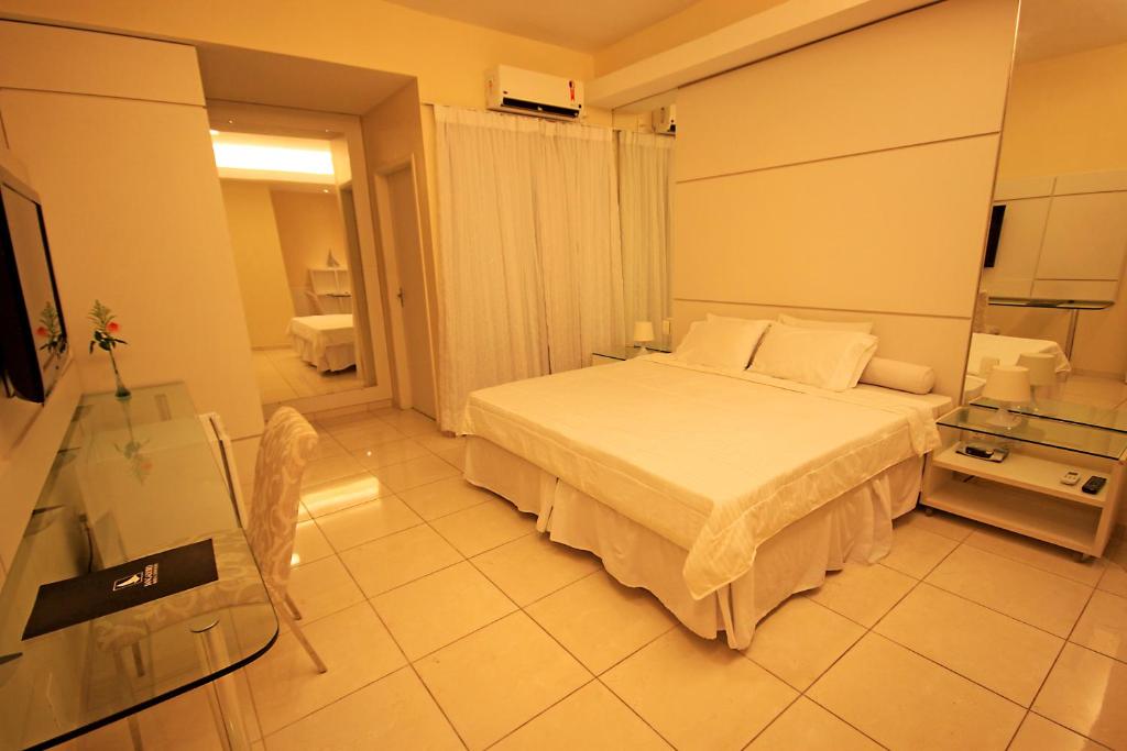 a bedroom with a white bed in a room at Hotel Jangadeiro in Recife