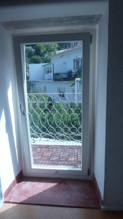 an open door with a view of a balcony at ribeira dos marinheiros amarelo in Sintra