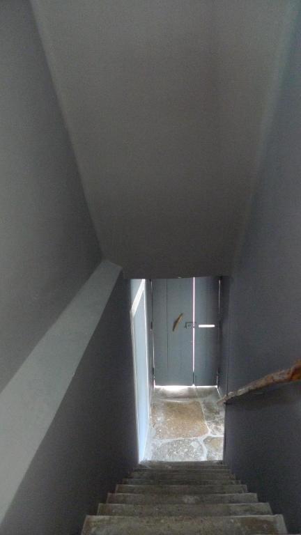 a stairway with a door in a room with stairs at ribeira dos marinheiros amarelo in Sintra