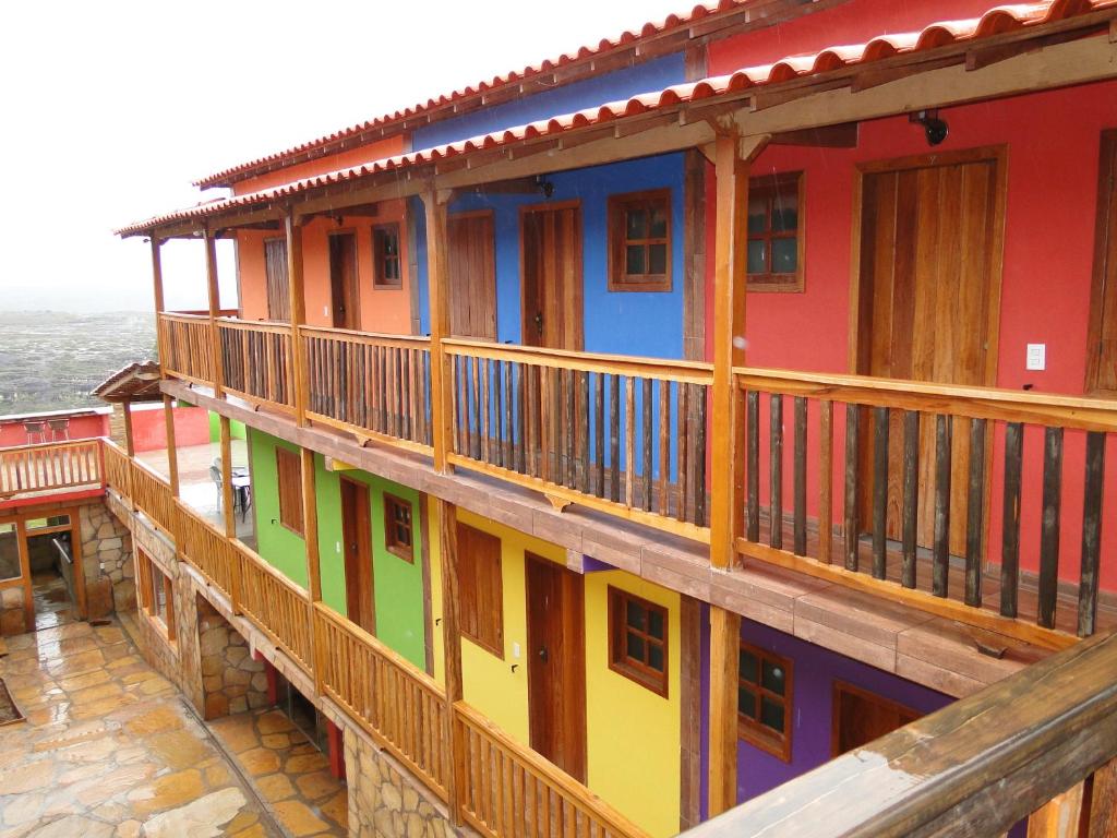 a row of colorful houses with balconies on them at Pousada Cachoeiras de Milho Verde in Milho Verde