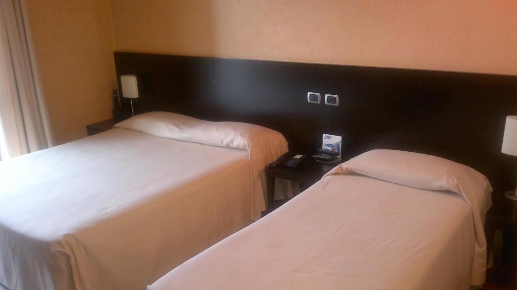 Postel nebo postele na pokoji v ubytování Hotel Aleramo