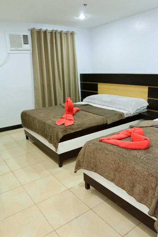 Postel nebo postele na pokoji v ubytování Global 88 Apartelle