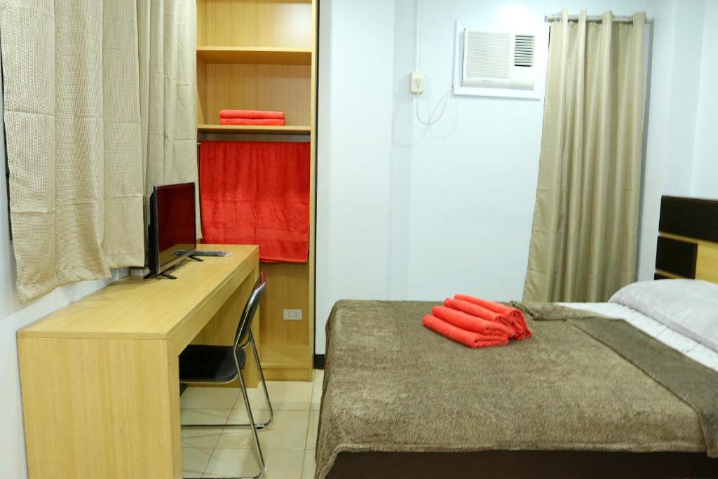 Postel nebo postele na pokoji v ubytování Global 88 Apartelle