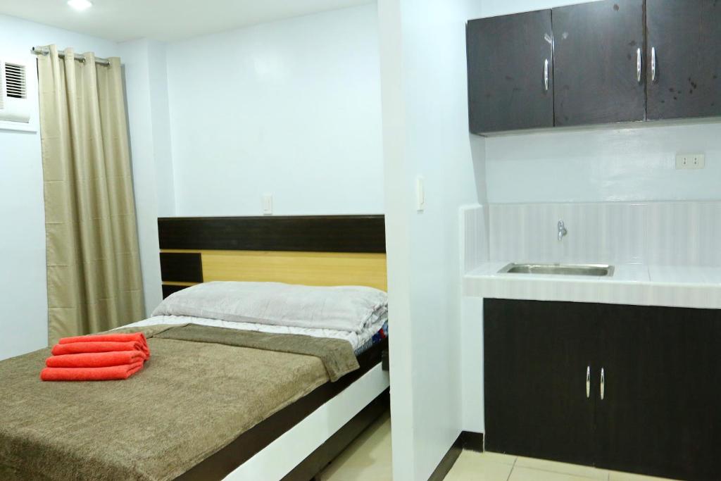Postel nebo postele na pokoji v ubytování Global 88 Apartelle