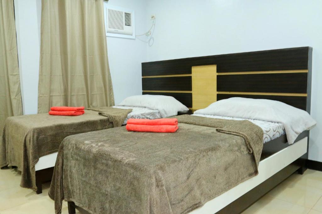 Postel nebo postele na pokoji v ubytování Global 88 Apartelle
