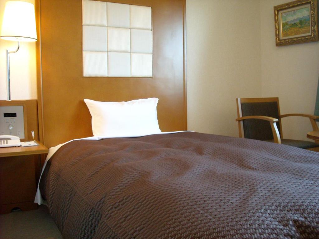 Postel nebo postele na pokoji v ubytování Komagane Premont Hotel