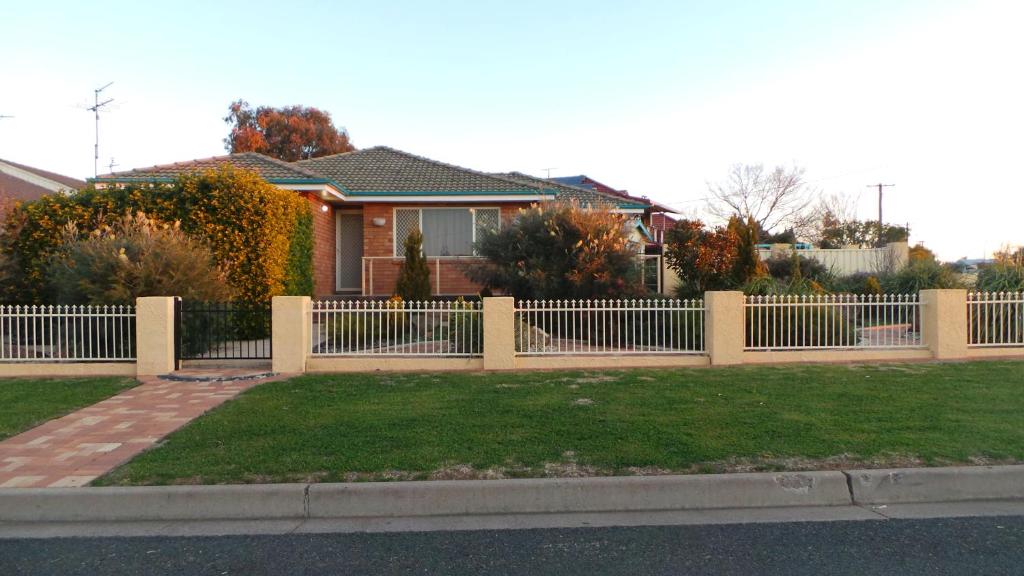 a white fence in front of a house at The Garden House in Tamworth