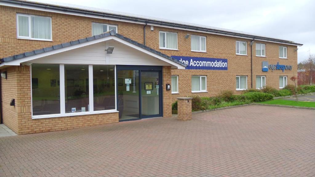 a large brick building with a large glass door at Eyesleepover in Eyemouth