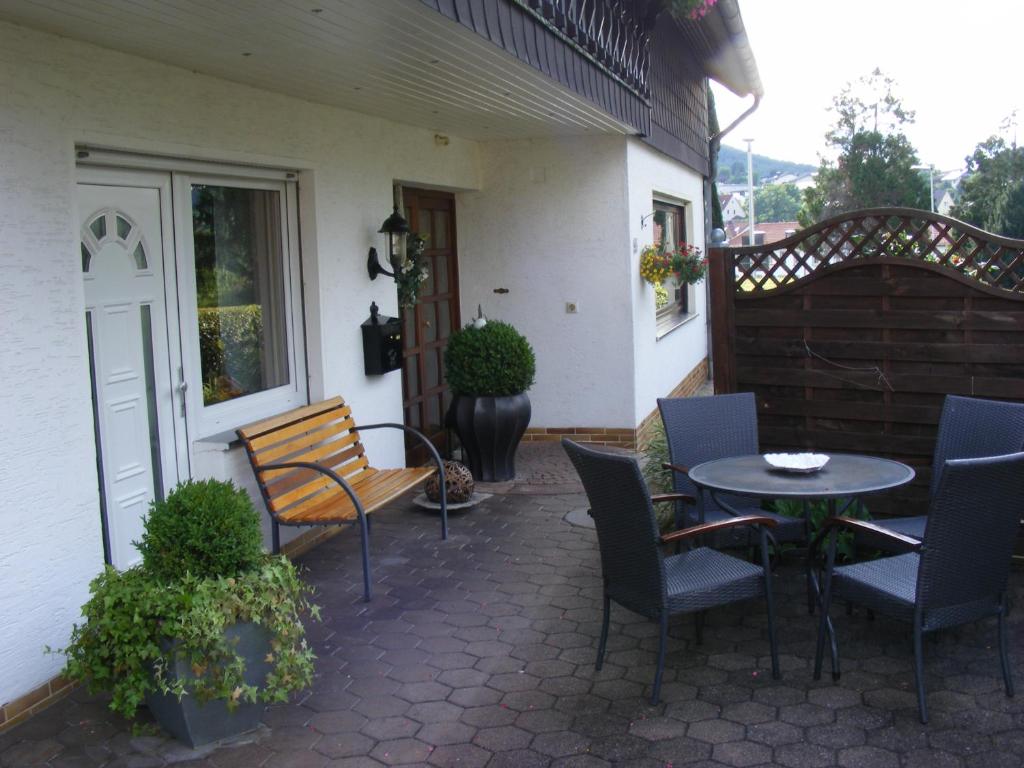 a patio with a table and chairs on a house at Ferienwohnung Gossel in Bad Wildungen