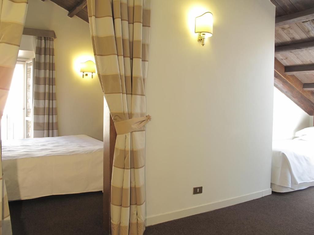 A bed or beds in a room at Hotel Albergo Santa Chiara