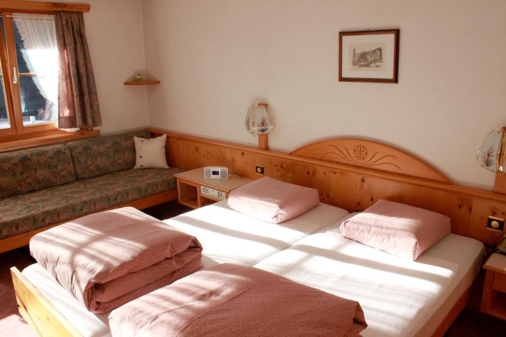 Łóżko lub łóżka w pokoju w obiekcie Hotel Soliva
