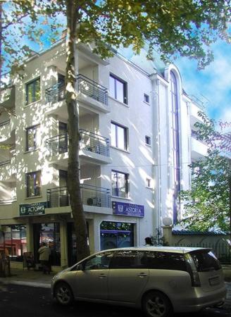 a van parked in front of a building at Hotel Astoria in Burgas