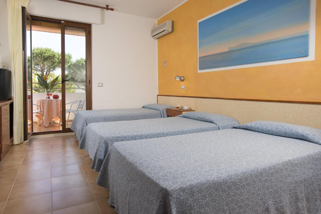 Postel nebo postele na pokoji v ubytování Hotel Oasis
