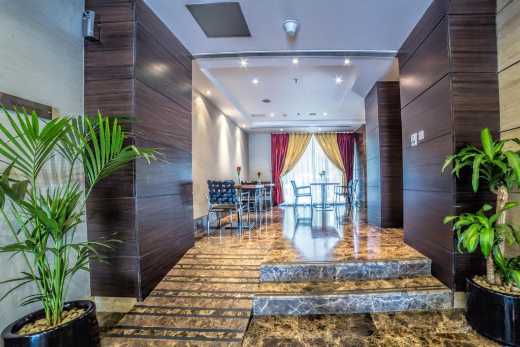 a lobby of a hotel with wooden walls and plants at Executive Suites Abu Dhabi in Abu Dhabi