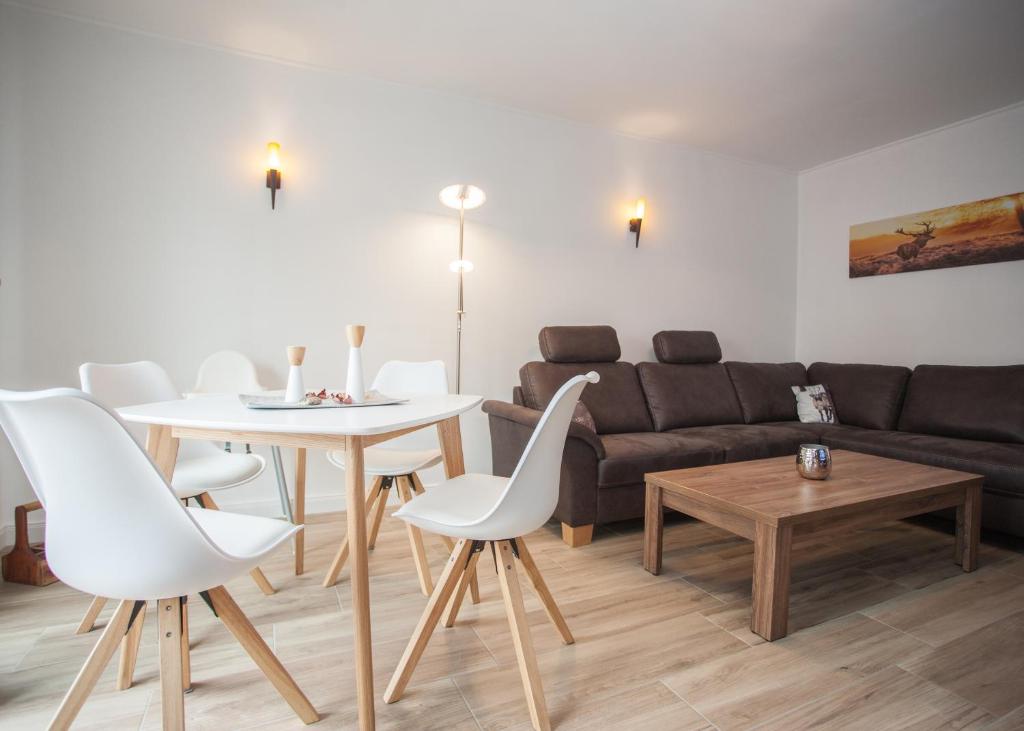 a living room with a table and chairs and a couch at Fichtenweg 31-S in Winterberg