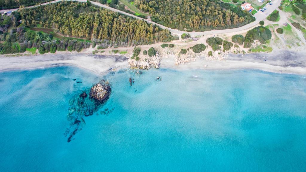 an aerial view of a rock in the ocean at Residence Isola dei Mori in SantʼAntìoco