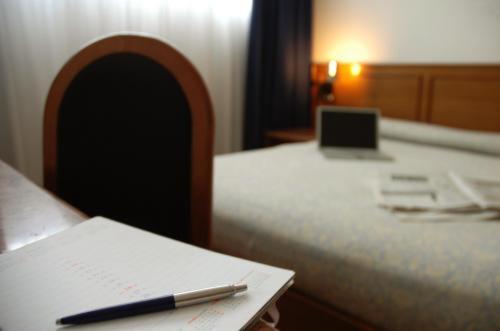 Postel nebo postele na pokoji v ubytování Hotel Cavallino