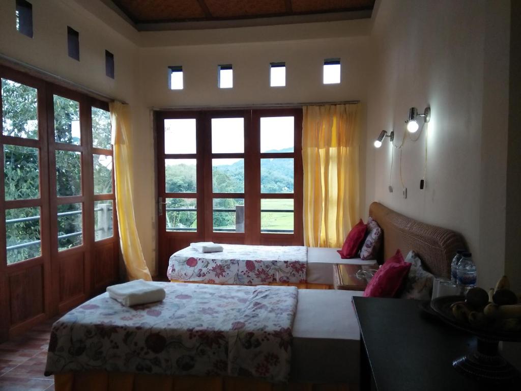 Postel nebo postele na pokoji v ubytování Rura Raya Homestay