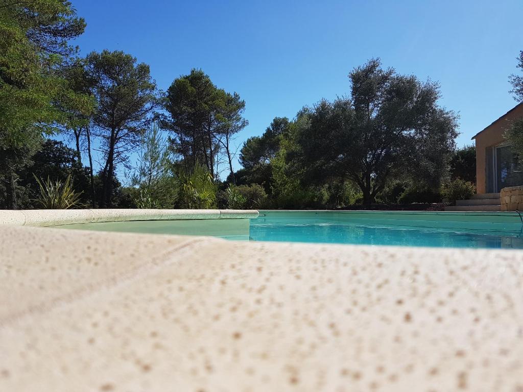 a close up of a sandy beach in front of a house at Séjour Pic Saint Loup in Saint-Mathieu-de-Tréviers