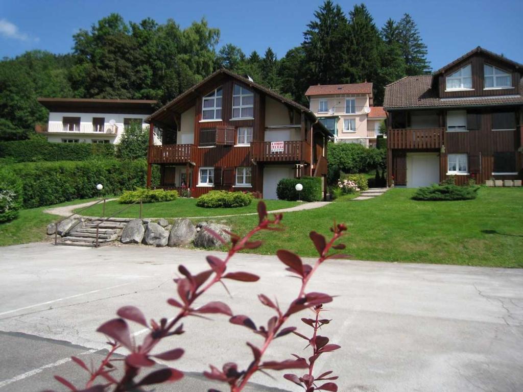 ein großes Haus mit einer Einfahrt davor in der Unterkunft Les Prairies du lac in Gérardmer